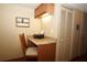 Compact office nook featuring granite countertop, overhead lighting, and convenient storage options at 8011 Peach Dr # 103, Tampa, FL 33637