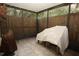 Enclosed patio featuring neutral tile flooring, partial shade, and wooden privacy fence at 8011 Peach Dr # 103, Tampa, FL 33637