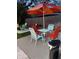 Backyard patio features an outdoor dining setup with seating, an umbrella and a BBQ grill in the background at 8129 23Rd N Ave, St Petersburg, FL 33710