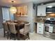Eat-in kitchen dining area with modern stainless steel appliances, granite countertops and stylish light fixture at 8129 23Rd N Ave, St Petersburg, FL 33710