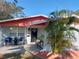 Charming single-story home featuring a well-maintained front yard and covered porch with seating at 8129 23Rd N Ave, St Petersburg, FL 33710
