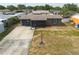 Aerial view of a single-story home with a driveway and yard at 8305 75Th Pl, Seminole, FL 33777