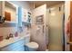 Bathroom with white vanity, toilet, and glass door shower at 8305 75Th Pl, Seminole, FL 33777