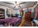 This bedroom features a ceiling fan and a cozy purple blanket on the bed at 8305 75Th Pl, Seminole, FL 33777