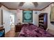 Comfortable bedroom featuring wood floors, ceiling fan, and a view to an ensuite bath at 8305 75Th Pl, Seminole, FL 33777