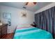 Comfortable bedroom with wood floors, ceiling fan, dresser, and wall decor at 8305 75Th Pl, Seminole, FL 33777