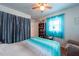Inviting bedroom with wood floors, ceiling fan, bookcase, and natural light at 8305 75Th Pl, Seminole, FL 33777