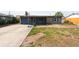Front exterior of a single-story home with a driveway and basketball hoop at 8305 75Th Pl, Seminole, FL 33777