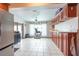Open kitchen design with tile flooring, granite countertops, and custom wood cabinetry at 8305 75Th Pl, Seminole, FL 33777