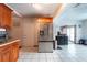 Modern kitchen featuring stainless steel refrigerator, tile flooring, and lots of cabinet space at 8305 75Th Pl, Seminole, FL 33777