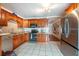 Well-lit kitchen with stainless steel appliances, tile flooring, and granite countertops at 8305 75Th Pl, Seminole, FL 33777