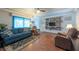 Spacious living room featuring wood floors, a ceiling fan and comfortable seating with good lighting at 8305 75Th Pl, Seminole, FL 33777