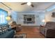 Inviting living room with hardwood floors, cozy seating, a ceiling fan and lots of natural light at 8305 75Th Pl, Seminole, FL 33777
