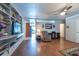 Cozy living room featuring hardwood floors, comfortable seating, built in shelving and a ceiling fan at 8305 75Th Pl, Seminole, FL 33777