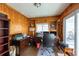 This room features wood paneled walls and a door to the outdoor deck at 8305 75Th Pl, Seminole, FL 33777