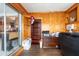 This room is wood paneled with access to the kitchen at 8305 75Th Pl, Seminole, FL 33777