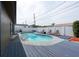 Backyard pool with a blue deck, white fence, lounge chairs and an outdoor dining table at 8305 75Th Pl, Seminole, FL 33777