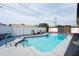 Backyard pool with a blue deck, white fence, lounge chairs and an outdoor storage shed at 8305 75Th Pl, Seminole, FL 33777