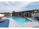 Backyard pool with a blue deck, outdoor storage shed and a sliding glass door entrance to the home at 8305 75Th Pl, Seminole, FL 33777