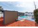 Backyard pool with a blue deck and red mulch and a view of the back of the house at 8305 75Th Pl, Seminole, FL 33777
