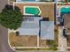Aerial view of home, featuring a private swimming pool and manicured backyard in a residential neighborhood at 8413 Lopez Dr, Tampa, FL 33615