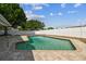 The vinyl privacy fence borders the rectangular in-ground pool and brick patio in this backyard setting at 8413 Lopez Dr, Tampa, FL 33615