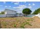 Exterior shot shows a two-story home, back patio, pool, and vinyl privacy fence at 8413 Lopez Dr, Tampa, FL 33615