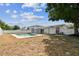 The backyard features an in-ground pool with a vinyl privacy fence, covered patio, and screened lanai at 8413 Lopez Dr, Tampa, FL 33615