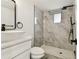 The bathroom is beautifully renovated with a decorative shower, sink and white cabinets at 8413 Lopez Dr, Tampa, FL 33615
