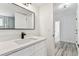 Stylish bathroom features a granite countertop, black faucet, and opens to a hallway with wood-look floors at 8413 Lopez Dr, Tampa, FL 33615