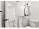 The bathroom has been renovated with gray wood look flooring, a bowl sink, and a modern light fixture at 8413 Lopez Dr, Tampa, FL 33615