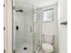 Modern bathroom featuring a glass shower with rainfall showerhead and a standard toilet at 8413 Lopez Dr, Tampa, FL 33615