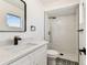 Bright bathroom with a modern vanity, patterned tile, and a sleek, glass-enclosed shower at 8413 Lopez Dr, Tampa, FL 33615
