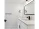 Bright bathroom featuring a modern vanity with granite countertops and a sleek, black faucet at 8413 Lopez Dr, Tampa, FL 33615