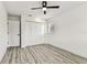 Bedroom with ample closet space, a modern ceiling fan, and durable wood-look flooring at 8413 Lopez Dr, Tampa, FL 33615
