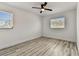 This bedroom features durable wood-look flooring and natural light from a window at 8413 Lopez Dr, Tampa, FL 33615