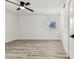 Clean bedroom featuring wood-look floors, ceiling fan and a window at 8413 Lopez Dr, Tampa, FL 33615