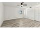 The bright bedroom has a modern ceiling fan, wood-look flooring, and a convenient closet at 8413 Lopez Dr, Tampa, FL 33615