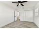 This bedroom features wood-look flooring, a ceiling fan, and a closet at 8413 Lopez Dr, Tampa, FL 33615
