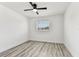 Sun-filled bedroom features wood-look floors, a modern ceiling fan, and a large window at 8413 Lopez Dr, Tampa, FL 33615