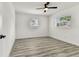 This bedroom has two windows with lots of natural light and vinyl plank flooring, a modern ceiling fan at 8413 Lopez Dr, Tampa, FL 33615