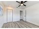 This bright bedroom features wood-look floors and includes a ceiling fan and double door closet at 8413 Lopez Dr, Tampa, FL 33615