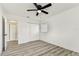 The bedroom features vinyl plank flooring, a closet and two windows with views of the neighborhood at 8413 Lopez Dr, Tampa, FL 33615