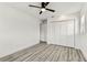 This bright, modern bedroom features a ceiling fan, closet, and durable wood-look flooring at 8413 Lopez Dr, Tampa, FL 33615