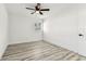 This bedroom features wood-look floors, a window, and white walls at 8413 Lopez Dr, Tampa, FL 33615