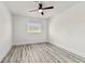 This bedroom features a modern ceiling fan, durable wood-look floors, and natural light at 8413 Lopez Dr, Tampa, FL 33615