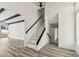 Bright entryway with light gray wood-look floors, black accents, and a staircase with a glass railing at 8413 Lopez Dr, Tampa, FL 33615