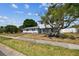 Charming two-story home with a well-manicured lawn and mature trees at 8413 Lopez Dr, Tampa, FL 33615