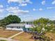 Two-story home with white siding, black shutters, and a large shade tree in the yard at 8413 Lopez Dr, Tampa, FL 33615