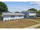 A two-story home featuring a striking turquoise door and meticulous landscaping at 8413 Lopez Dr, Tampa, FL 33615